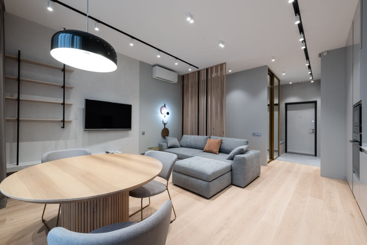 Apartamento com sala de estar e sala de jantar integrados e decorados em estilo minimalista.